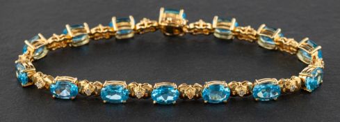 An oval, mixed-cut, blue topaz and diamond bracelet, total estimated topaz weight ca. 12.