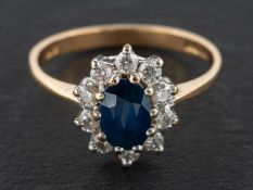 A 9ct gold, sapphire and round, brilliant-cut diamond cluster ring, estimated sapphire weight ca. 1.