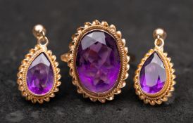 A 9ct gold, oval, mixed-cut amethyst ring and pair of drop earrings, with ropework surround,