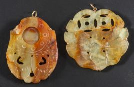 Two carved bowenite serpentine pendants, one depicting a pair of doves, the other of foliate motif,