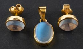 An oval, cabochon-cut moonstone pendant and pair of ear studs, the ear studs with post fittings,