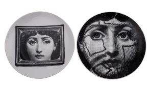 Two Fornasetti Tema e Variazioni wall plates one printed with stitched visage [n.