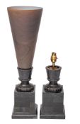 A pair of bronze table lamps, of urn-shaped outline: with trumpet-shaped flared shade,