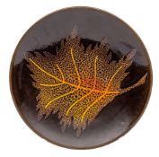 A Poole pottery Agean plate, with yellow and orange leaf decoration on a brown ground,