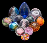 A collection of glass paperweights including examples by Mdina, Whitefriars and The Glass Eye,