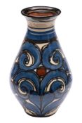 A Darico Pottery 'Skønvirke' vase of baluster form with slip trailed scrolling decoration in blue,