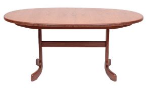 A teak extending oval dining table and a set of six teak dining chairs, by G-Plan,