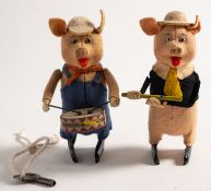 A pair of Schuco clockwork Walt Disney 'Three Little Pigs' figures,