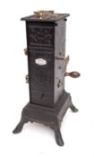 A 19th Century French clockwork spit engine in blackened tin and metal casing,