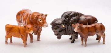 A group of John Beswick cattle comprising a Limousin bull, a Limousin calf,