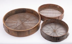 A group of three bentwood sieves.