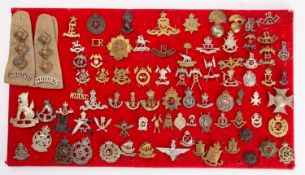 A collection of British and Colonial Army Regimental cap badges, including 18th Bengal Lancers,