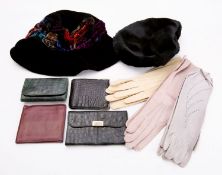 A Hermes burgundy leather wallet, together with a crocodile skin wallet, two crocodile skin purses,