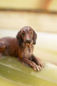 A mid 20th century cold painted bronze model of a dog on a green onyx pen stand base:,10.