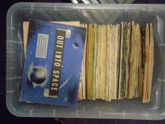 A collection of Brooke Bond Trade cards in albums, including 'Out Into Space' and others.