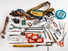 A collection of fly tying equipment and accessories, including steel hooks,
