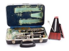 A Bousey & Hawkes 'Regent' clarinet in case, together with a Wittner metronome.