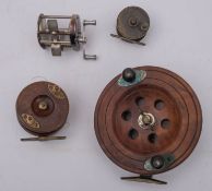 A late 19th century mahogany and brass star back reel, with double horn handles,