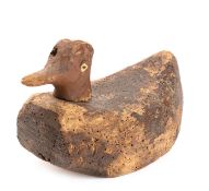 A late 19th/early 20th century decoy duck with traces of original decoration, 28cm long.