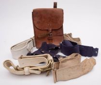 A Royal Marines brass waist belt clasp on white webbing belt, together with five other belts,