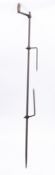 A hand driven iron spit with twin tines, having turned wood handle, 210cm long.