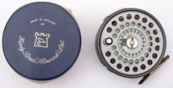 A Hardy 'St Andrew' 4 inch alloy fly reel, ebonised handle, tension screw to rim and brass foot,