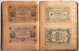 An old album of banknotes, primarily Russian, Japanese, Chinese,