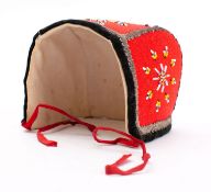 An early 20th century Scandinavian child's bonnet: with traditional beaded decoration.