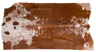 A cow hide rug: 204 x 120cm.