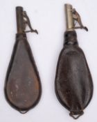 Two leather shot flasks with thumb lever measure,
