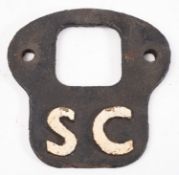 A cast iron locomotive 'SC' (self cleaning) plate.