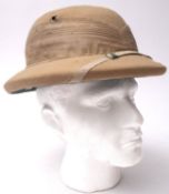 An Ango-Indian Pith helmet, label to interior ' Express Yead & Co' 53cm.