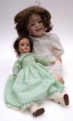 An Armand Marseille bisque head doll, black wig, blue glass sleeping eyes,