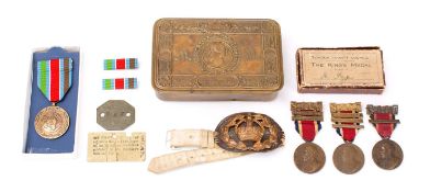A WWI period 1914 Christmas tin, together with three London County Council King's Medals,