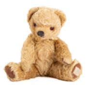 A Merrythought blonde plush Teddy bear with glass eyes, stitched nose and mouth,