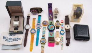A group of six Swatch watches together with a collection of other various wristwatches.