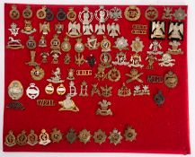 A collection of British and Commonwealth Regimental cap badges, including Tank Corps,
