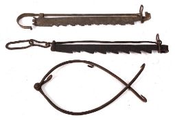 Two wrought iron adjustable pot hooks of serrated design,