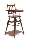 A child's beech folding high chair, the back with triple vertical splats,