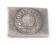 A German Army belt buckle, aluminium cast pebble type with eagle and legend to centre.