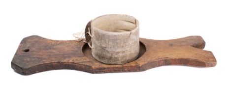 A drum-shaped cheese strainer and press, the wooden board of shaped outline with circular recess.