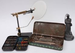 A collection of various fly fishing equipment including a fly tying stand, lines, fly cases,