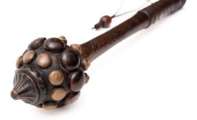 An Oceanic style war club, the pommel with three rows of knops on a carved shaft,