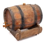 A coopered barrel with tap, on a wood stand, 32cm long.