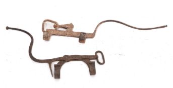 Two wrought iron kettle tilts of plough pattern, 18th Century.