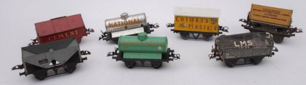 An unboxed group of Hornby O gauge rolling stock, comprising a Cement wagon,