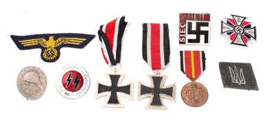 A small collection of reproduction German military medals and badges.