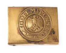 A German Army belt buckle, brass with eagle and legend to centre.