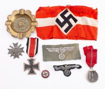 A German NSDAP armband, together with a NSDAP enamel badge, a trench art ashtray,