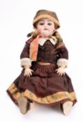 A late 19th century continental bisque head doll, applied brunette wig ,